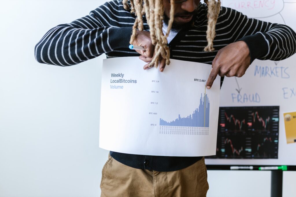 A Man Holding a Paper About Crytocurrency