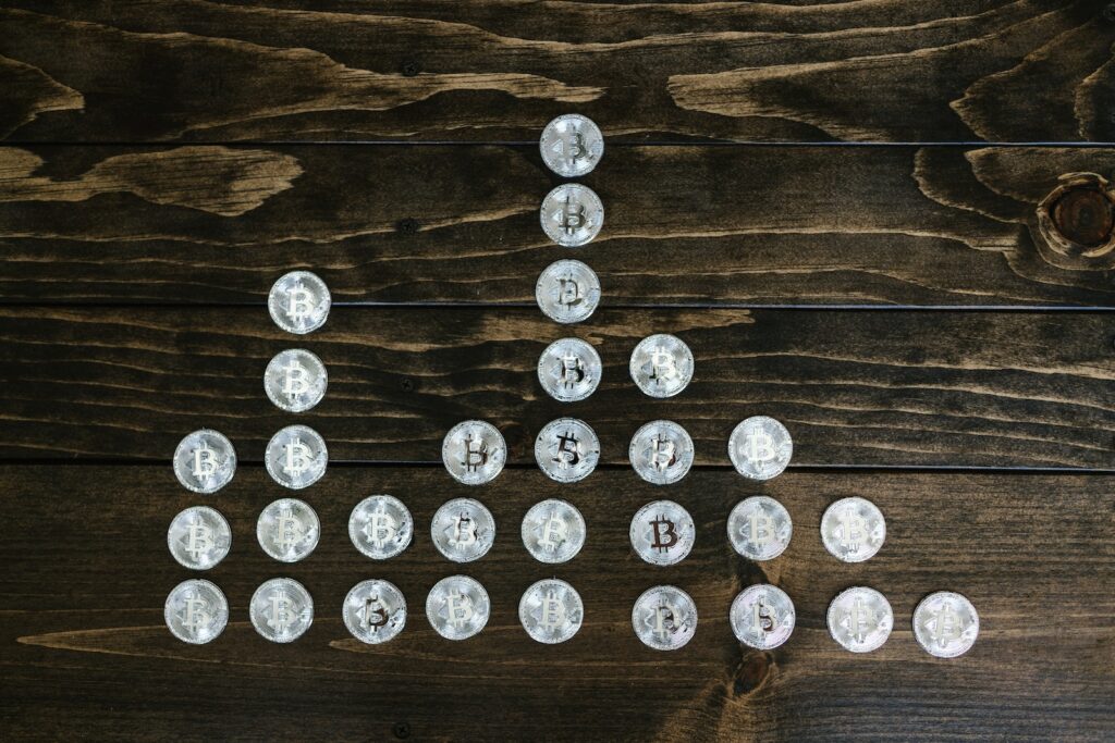 Silver Round Coins on Brown Wooden Surface